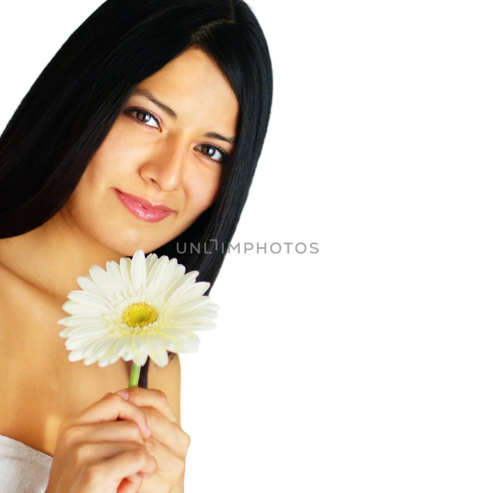 Beautiful young spa woman holding a flower against white.