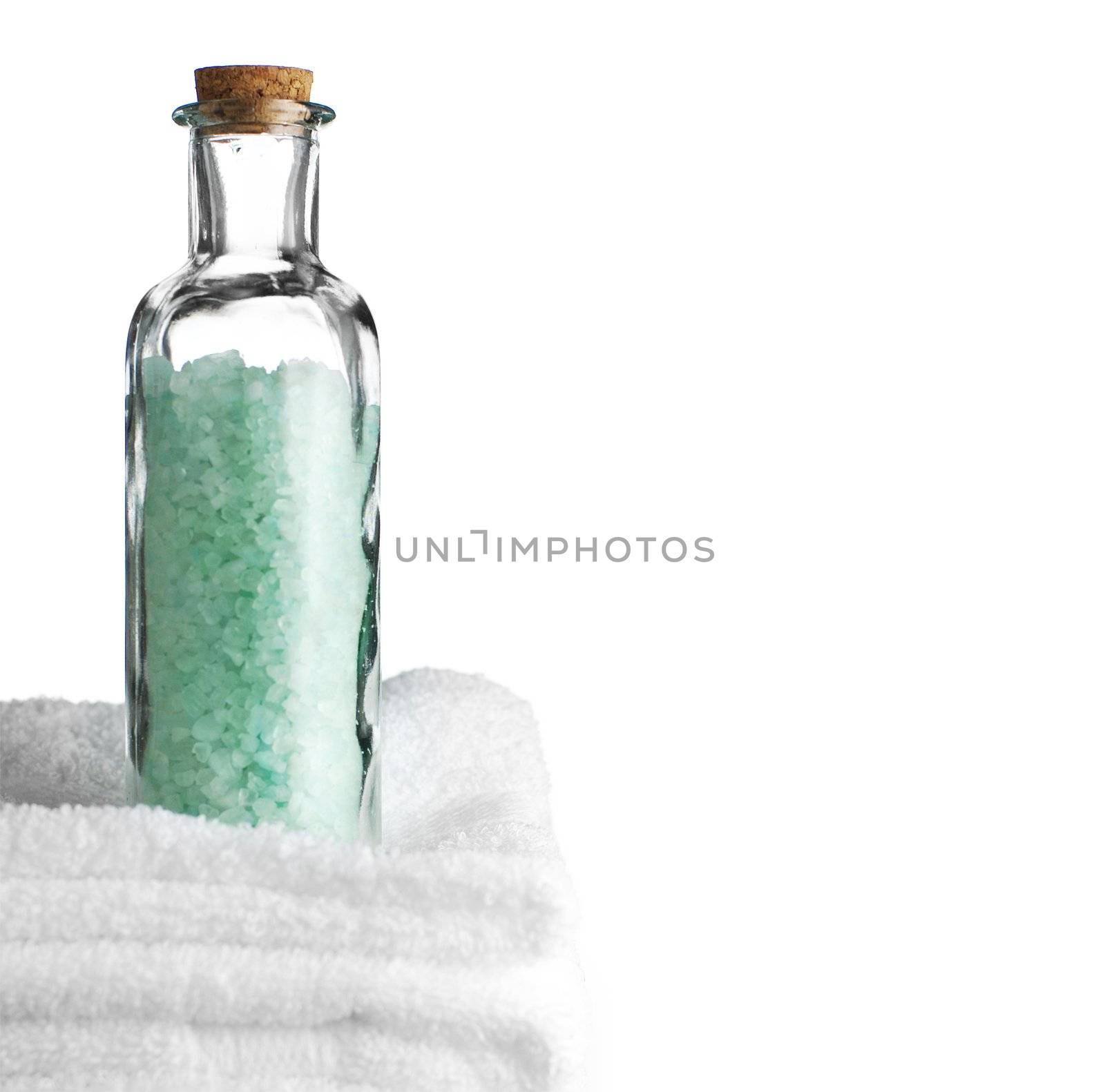 Bath towels and bath salt against a white background.