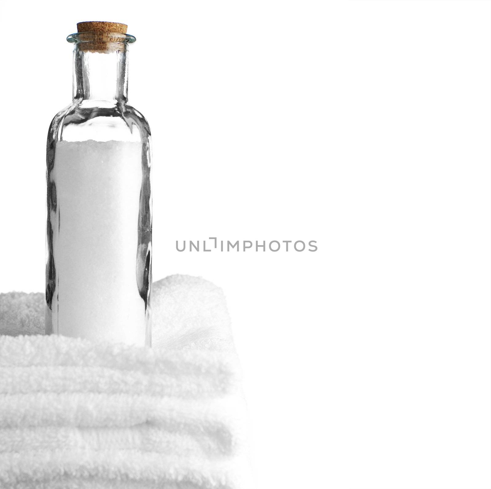 Bath towels and bath salt against a white background.