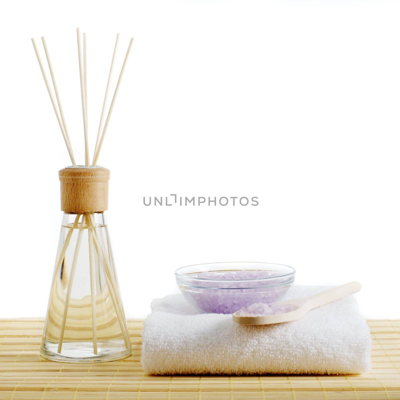 Spa scene on top of a bamboo mat and against a white background.