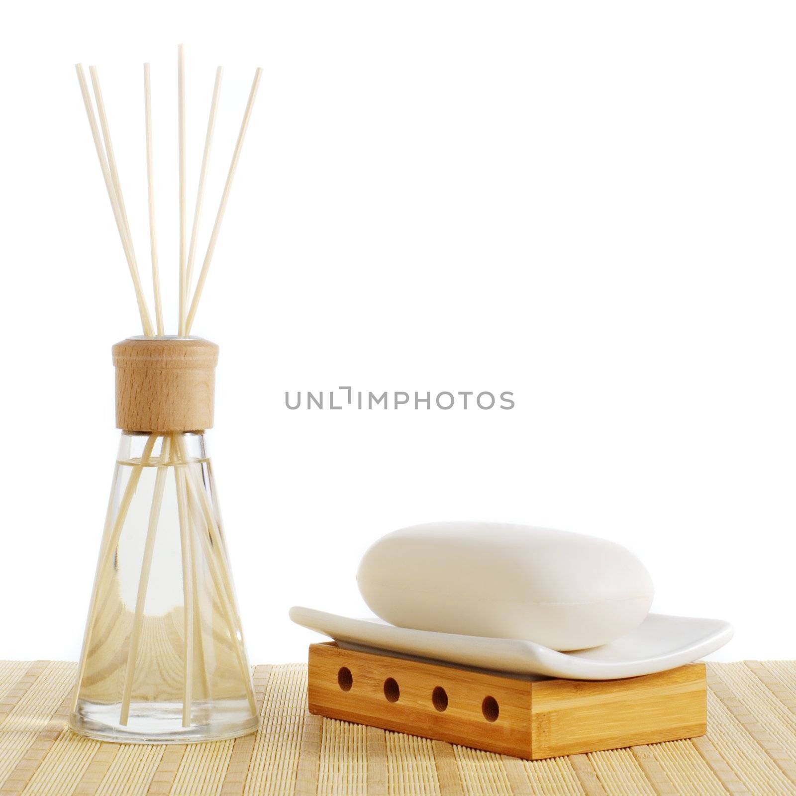 Reed diffuser and soap against a white background.