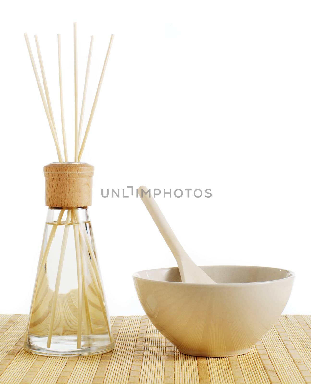 Reed diffuser and bowl of treatment against a white background.