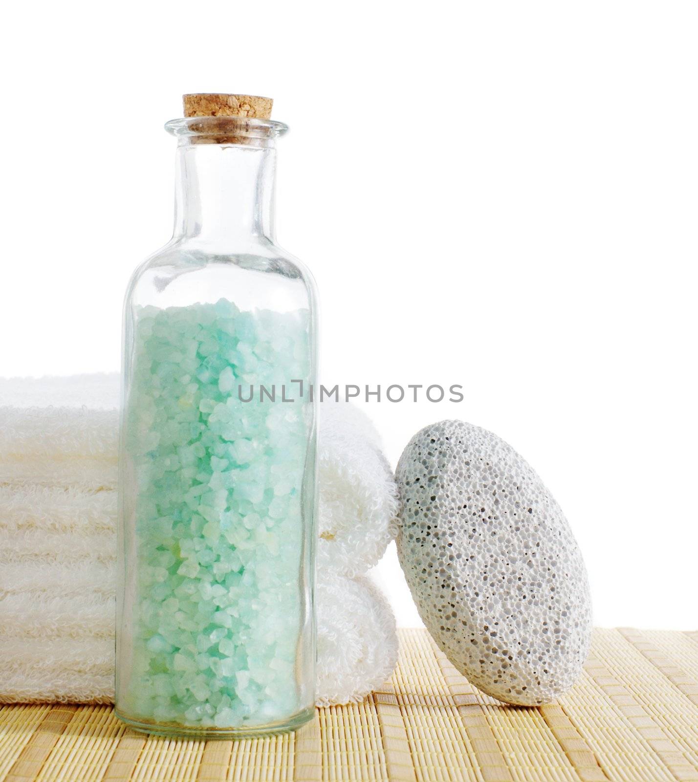 Bath salt, towels, and pumice stone against a white background.