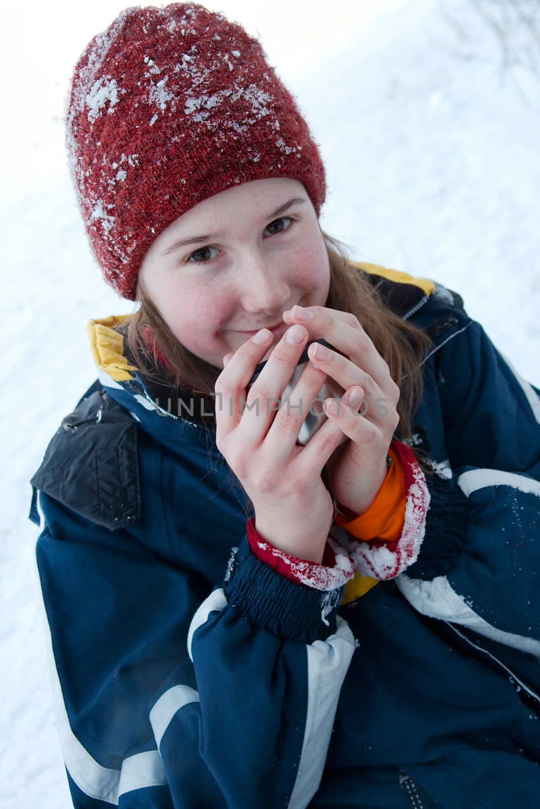 Girl drinking hot tea in the cold winter