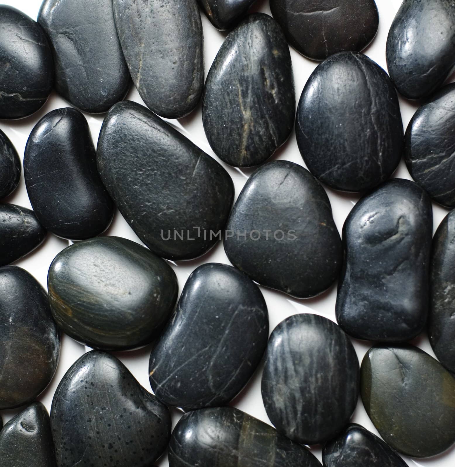 Group of black river rocks on display.