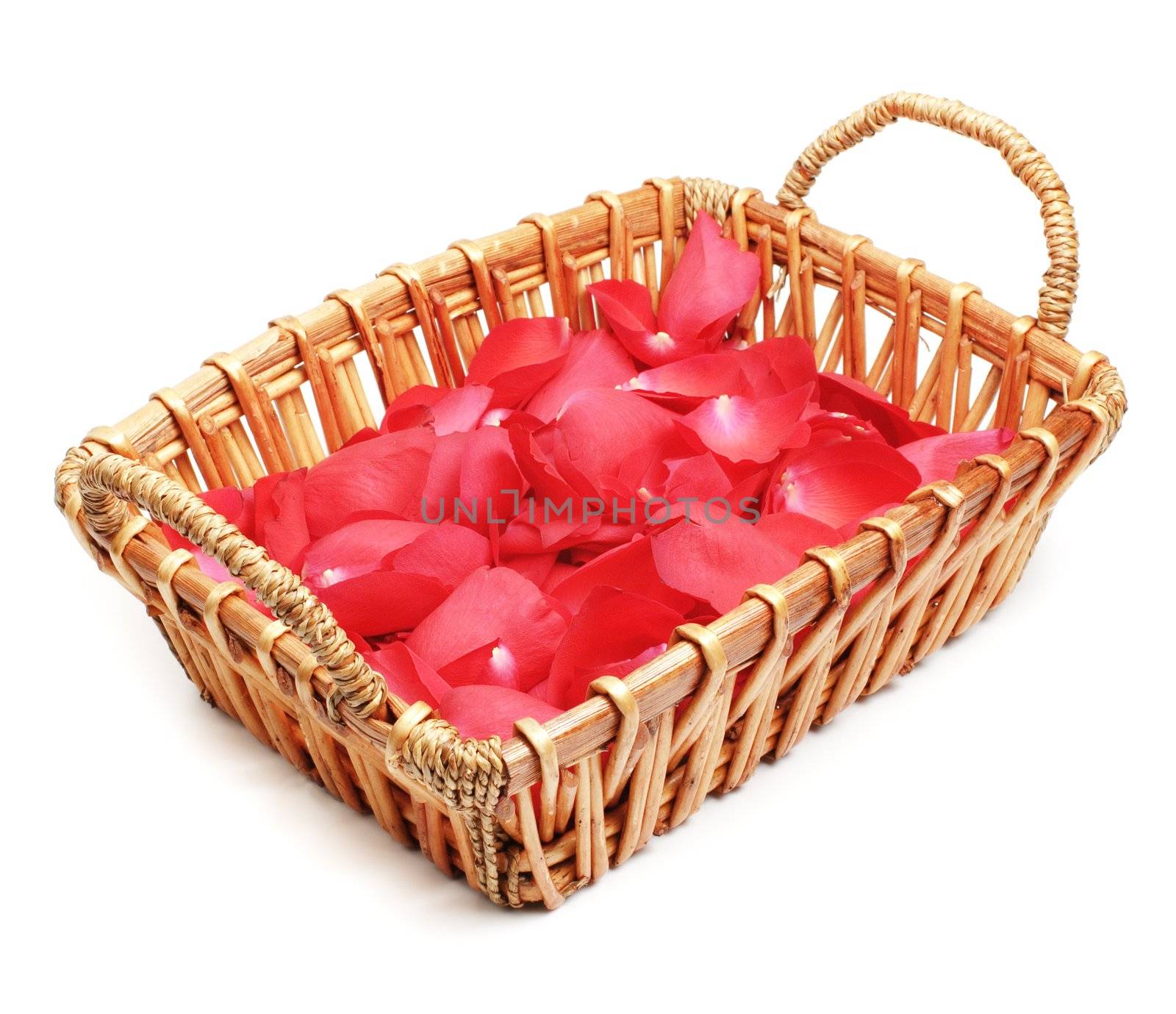 Basket full of rose petals on display against white.