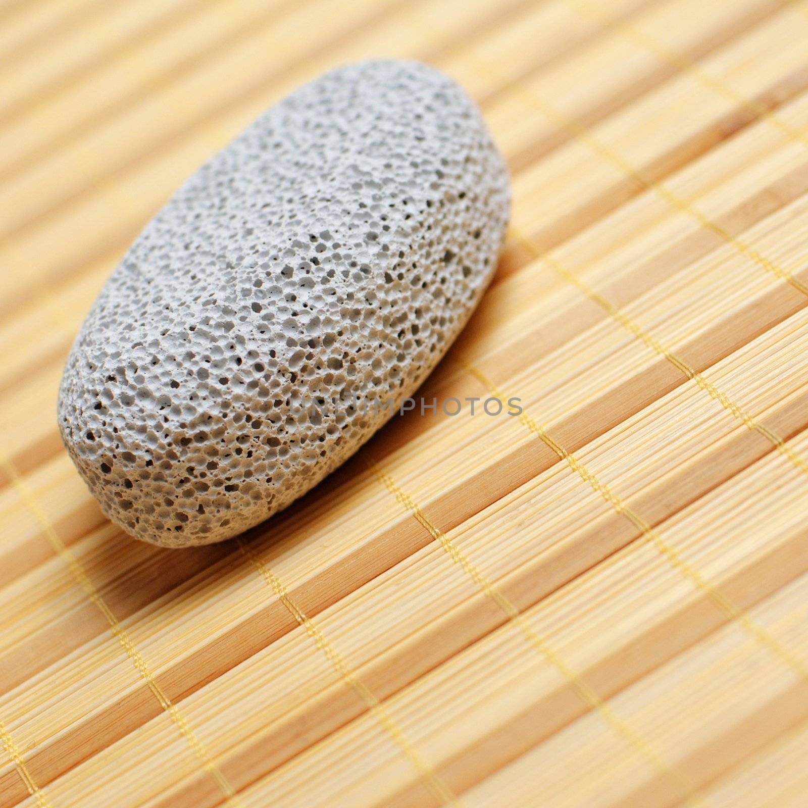 Pumice stone close up on a bamboo mat.
