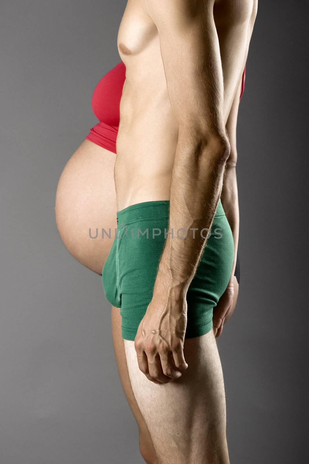 Pregnancy Concept - A nine months pregnant woman and a very skinny man