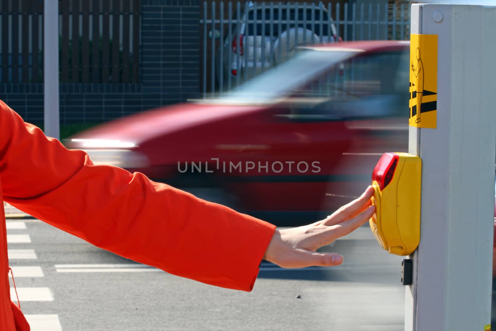 Woman pressing the button on the pedestrian crossing