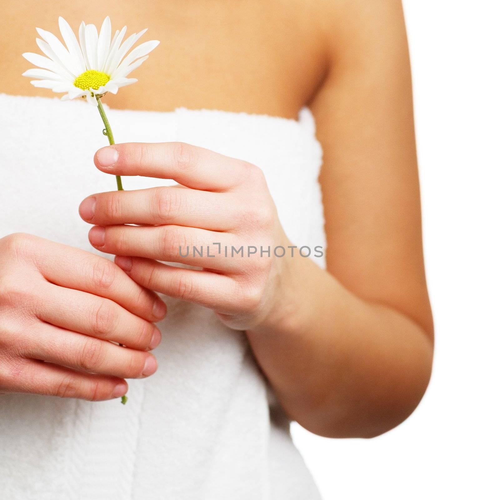 Close up of a spa woman holding a flower.