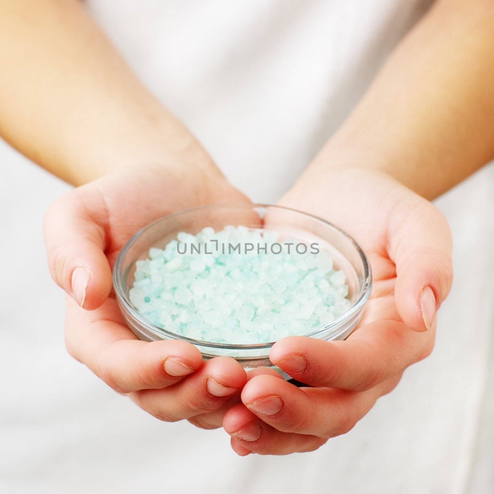 Closeup of womans hands holding spa treatment.