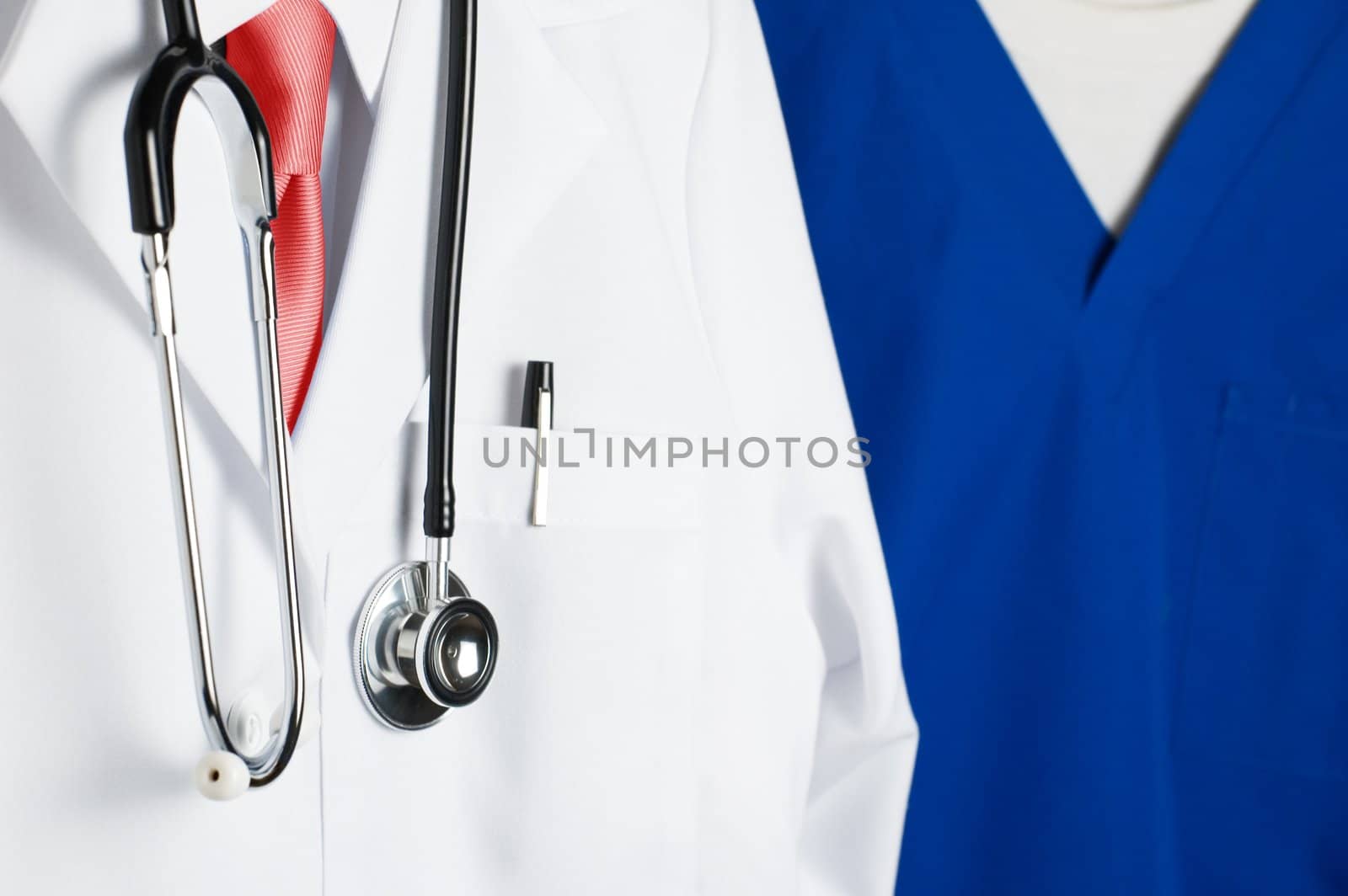 Closeup shot of doctor and nurse in blue scrubs.