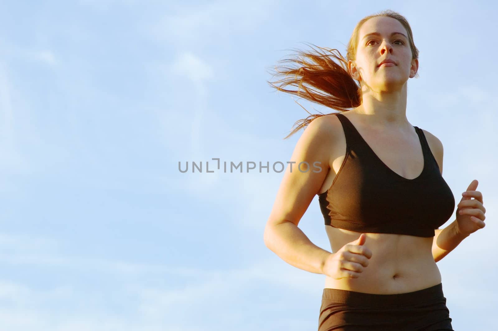 Beautiful young woman runner having a workout session.