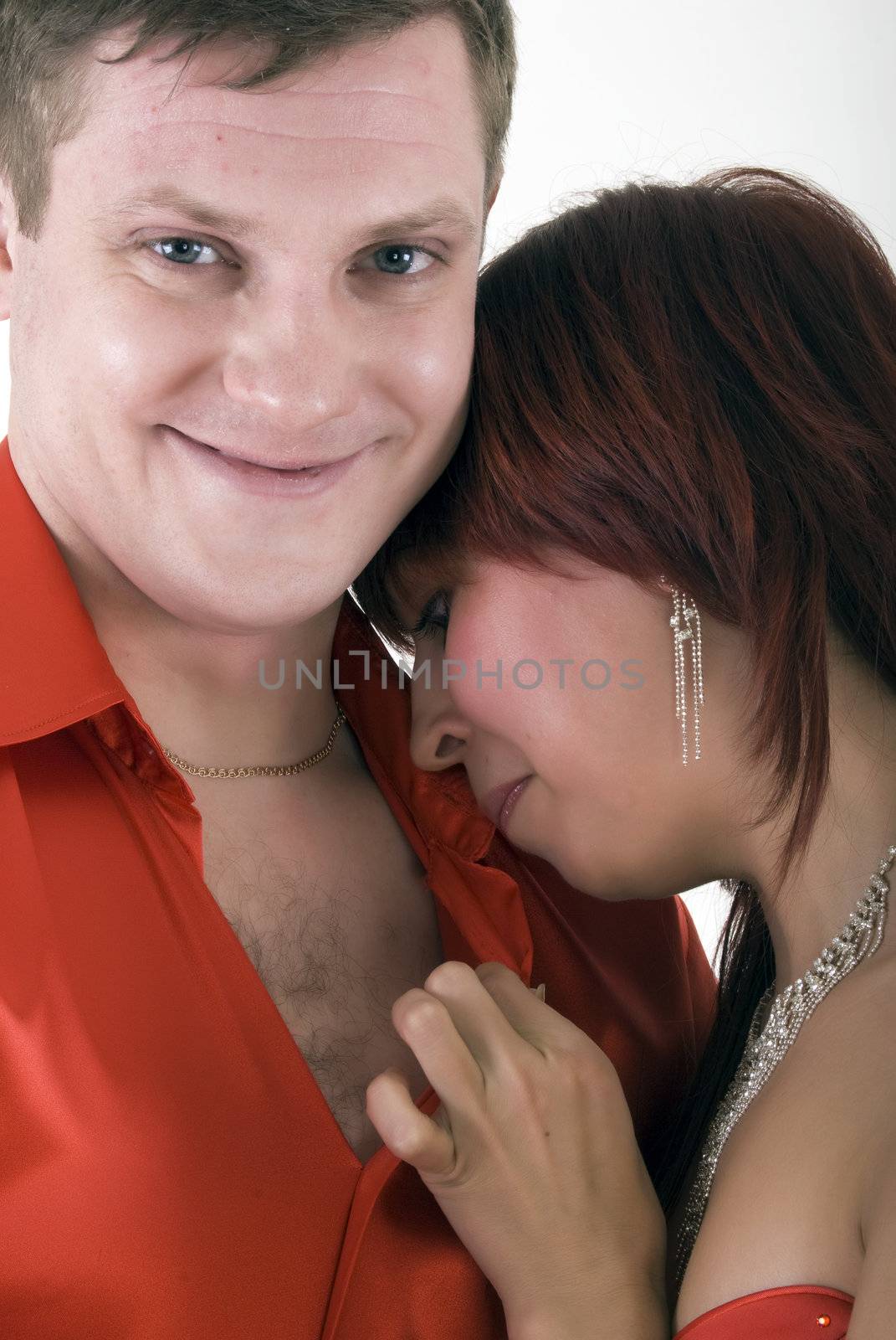 Young couple in red  as a concept of love and passion