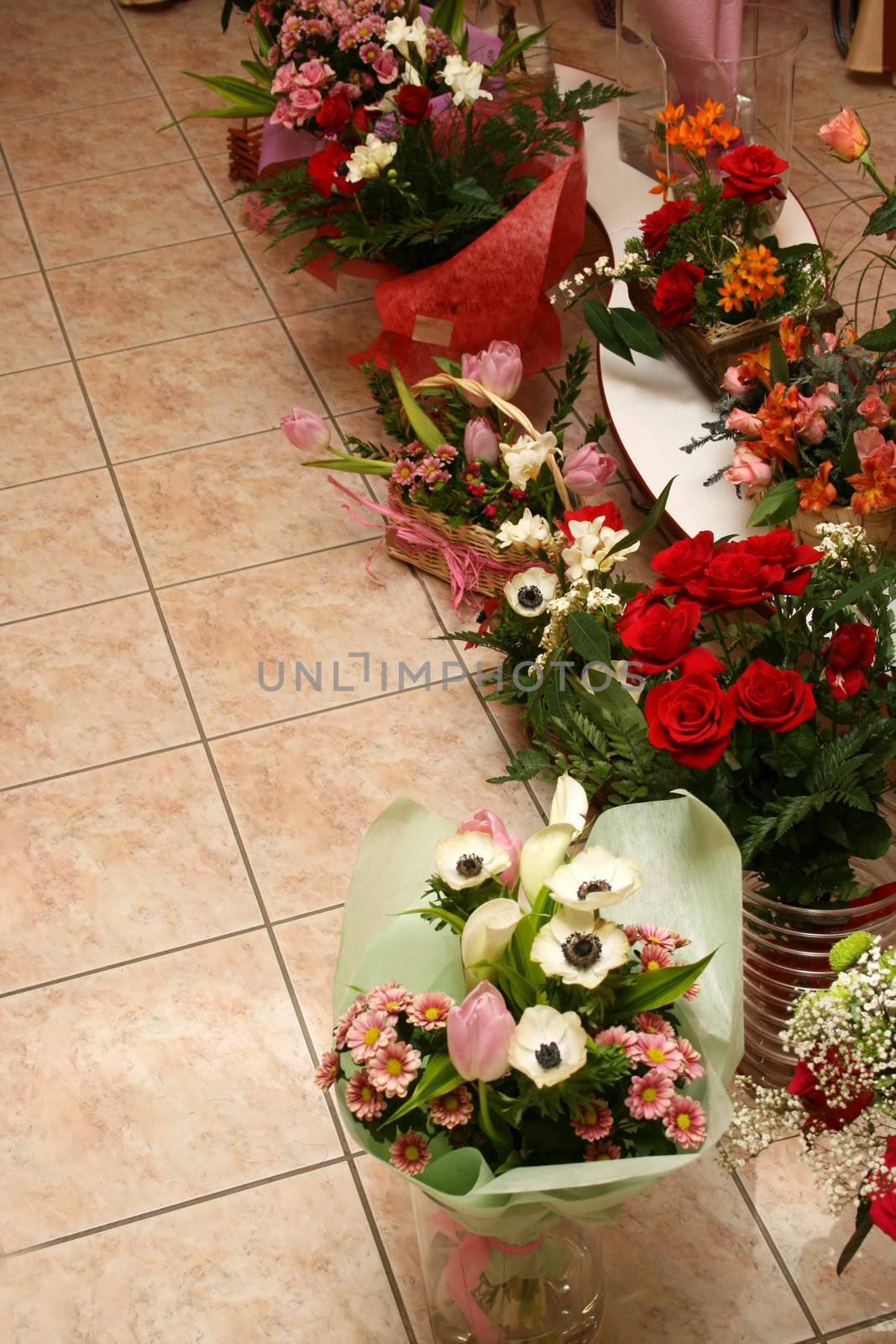 Different flowers on marble to a floor in flower shop