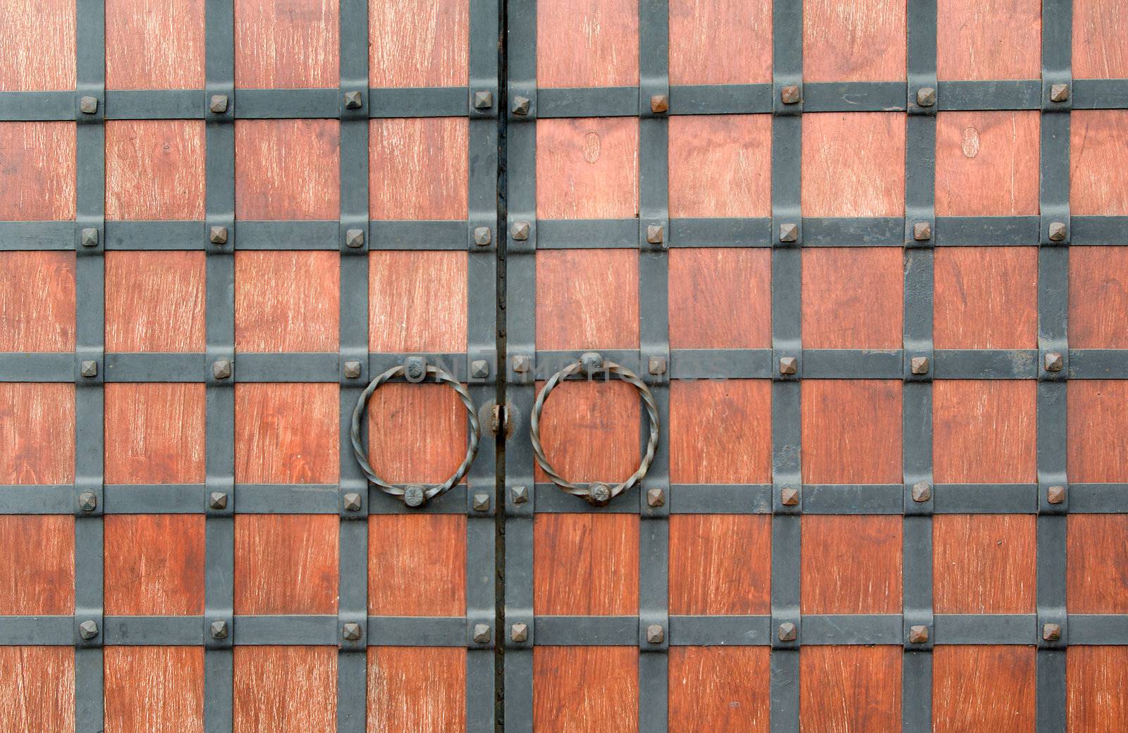 Old wooden closed textured door.metal handle on old wood door