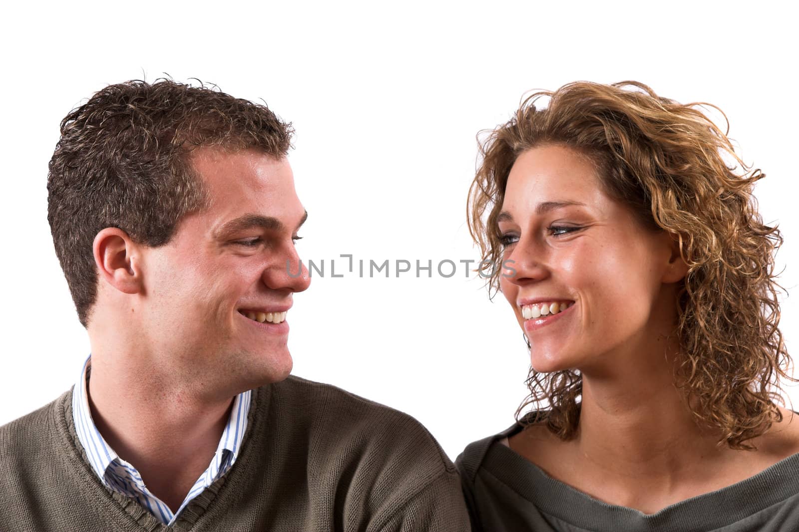 Young couple looking at eachother on white background