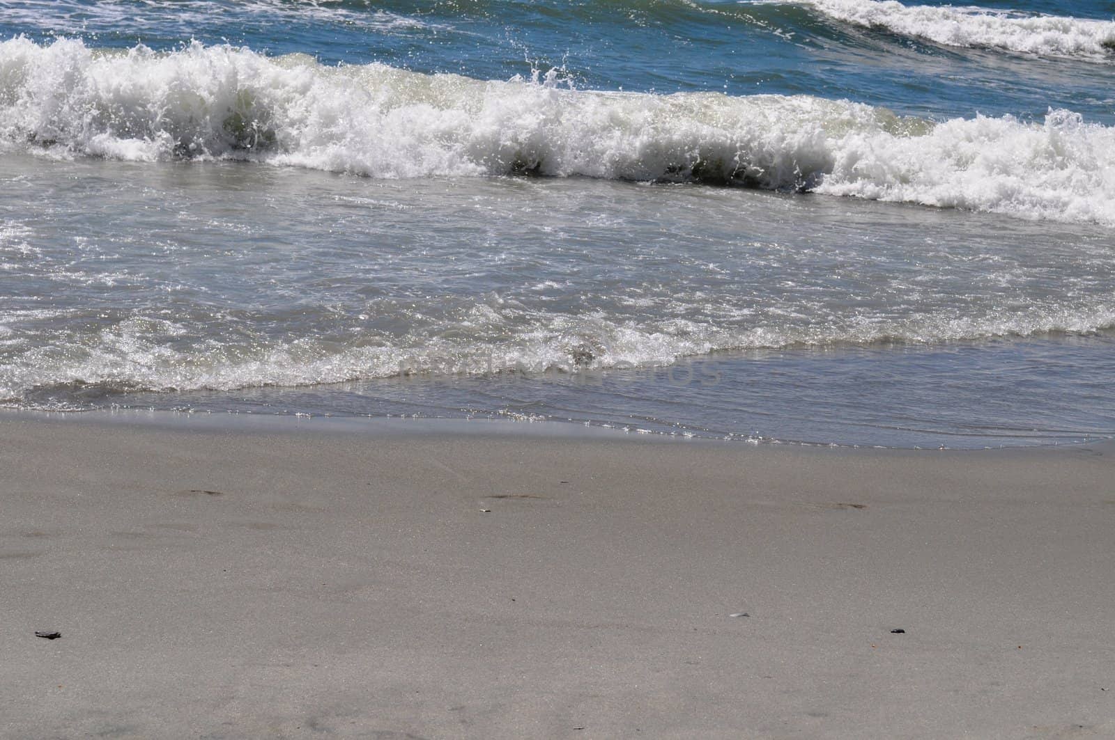 Sand and waves by RefocusPhoto