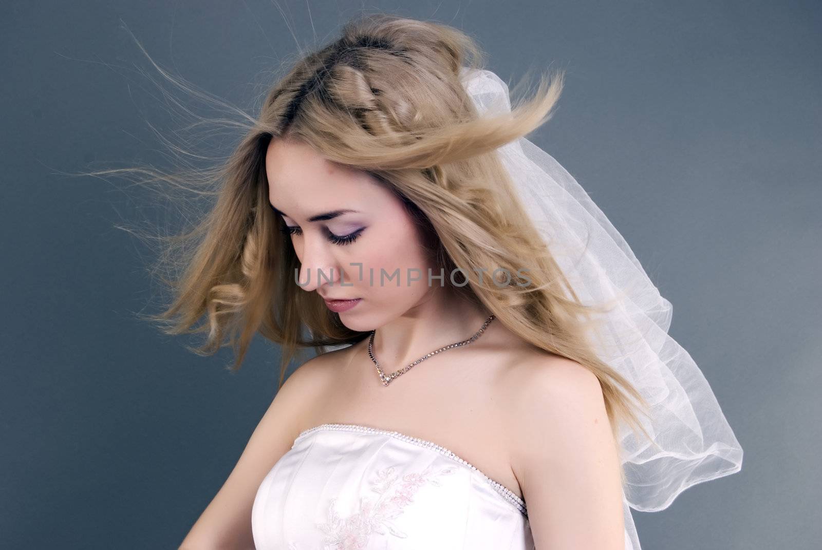 Young beautiful bride looking sad