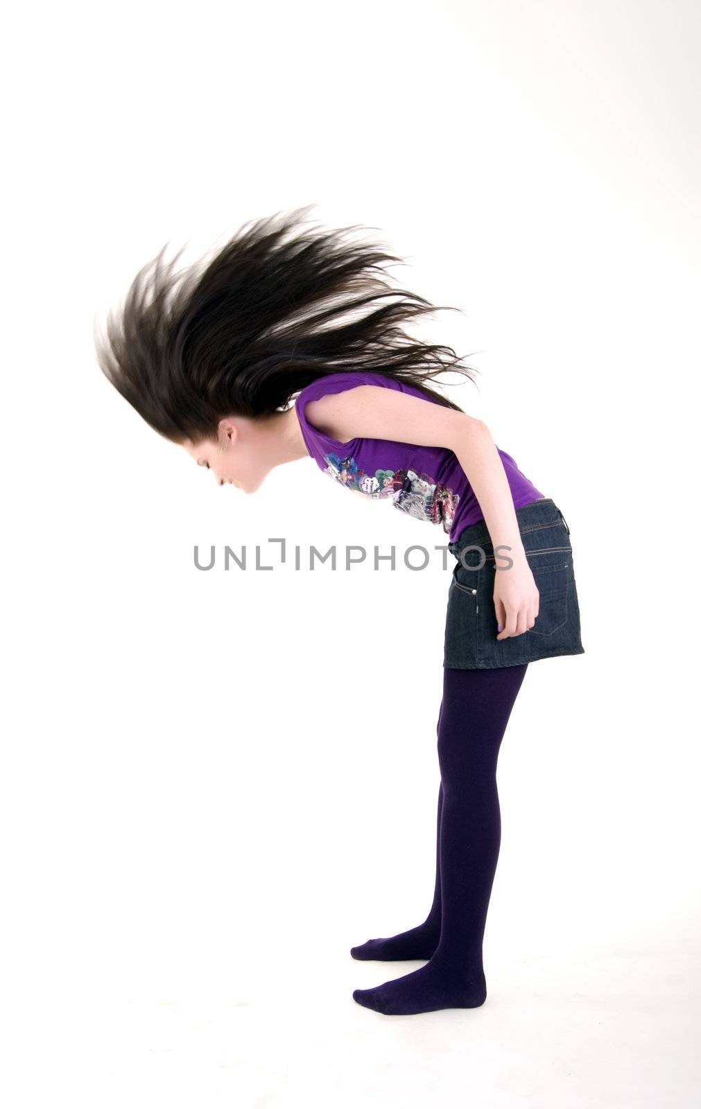  Portrait of a young beautiful brunette shaking her head