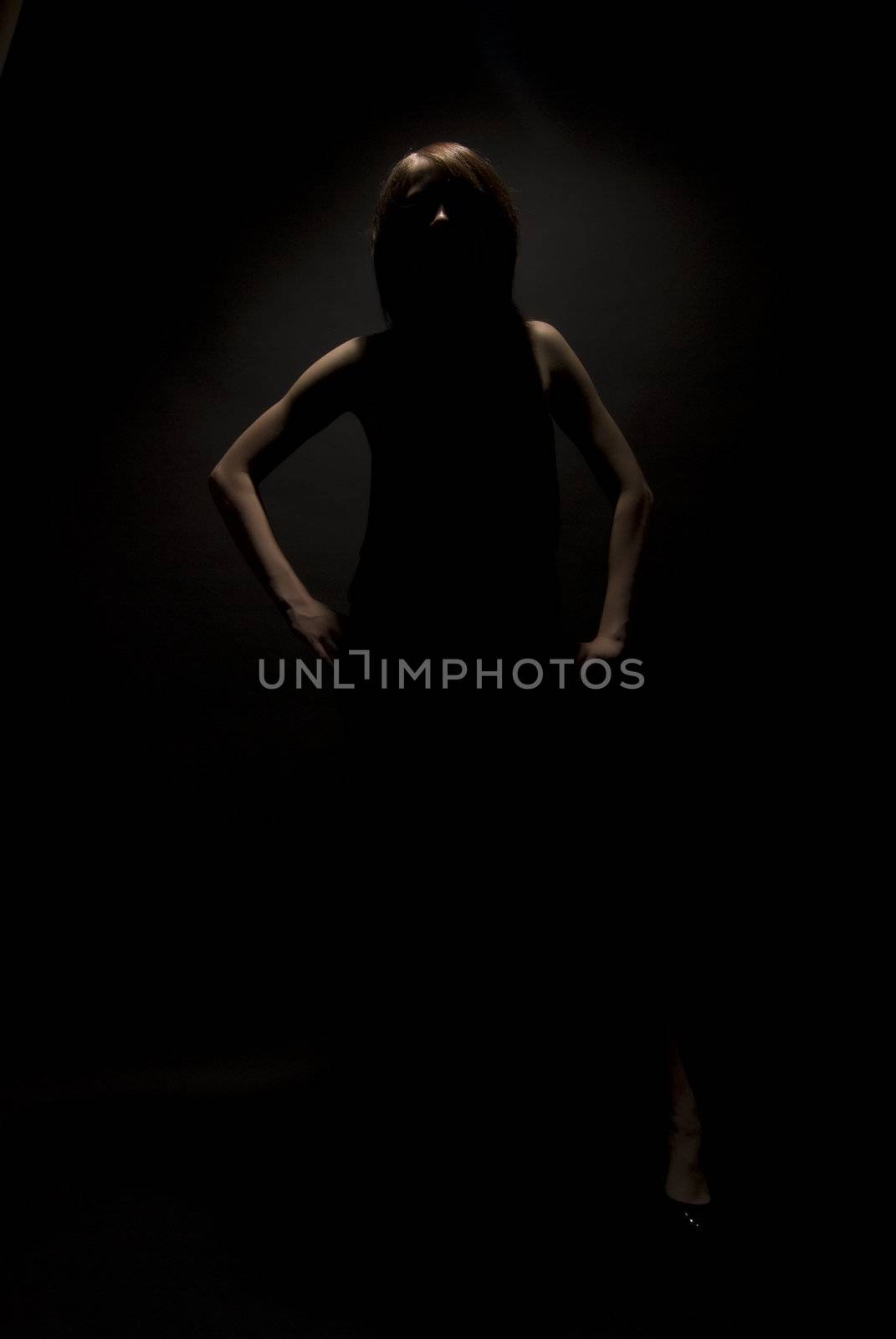 Portrait of a young beautiful girl in darkness