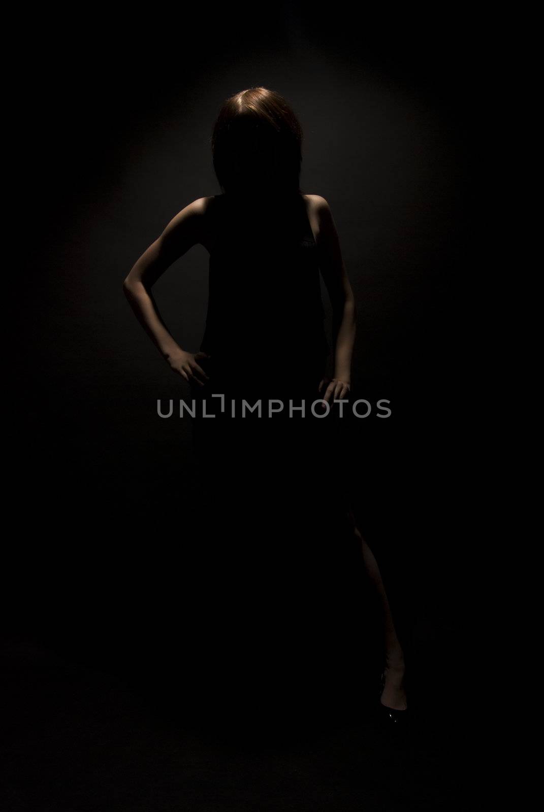 Portrait of a young  brunette in darkness