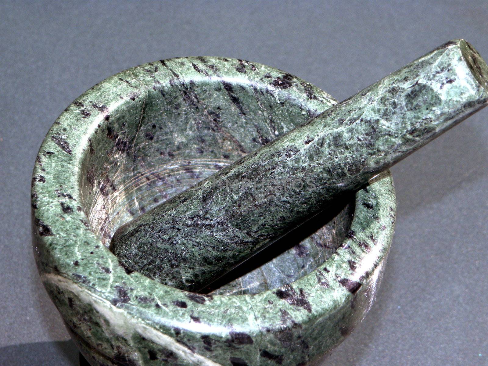Photo presents one, green mortar with pestle.