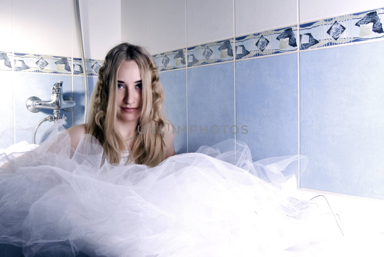 young pretty bride posing in bathroom