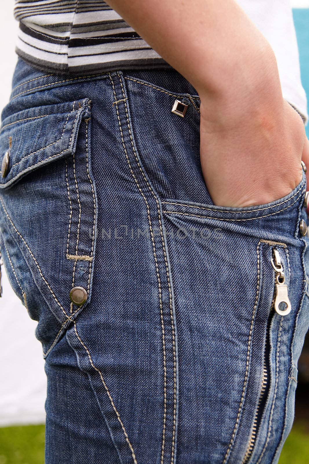 Closeup of cool blue jeans and man hands in pocket