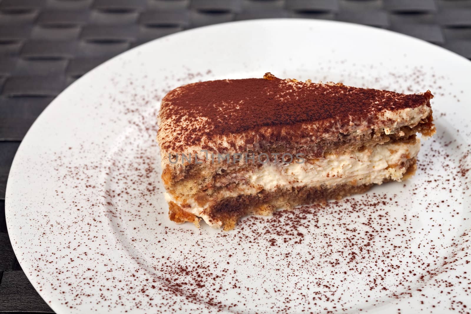 slice of a tiramisu cake on a white plate by bernjuer