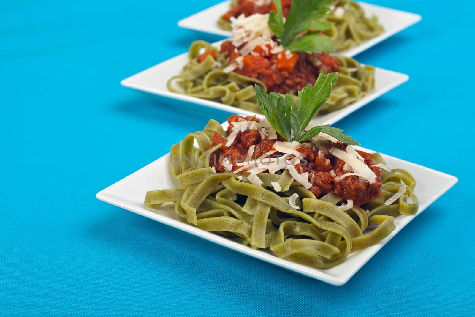 tagliatelle with sauce bolognaise in white plates