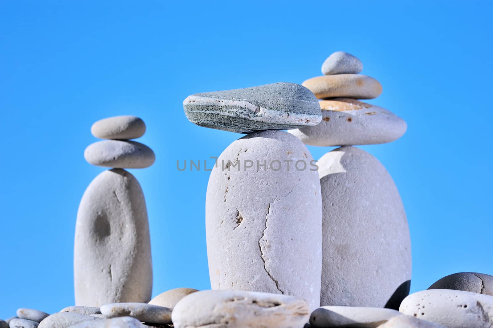Balance of small stones on three long cobblestones