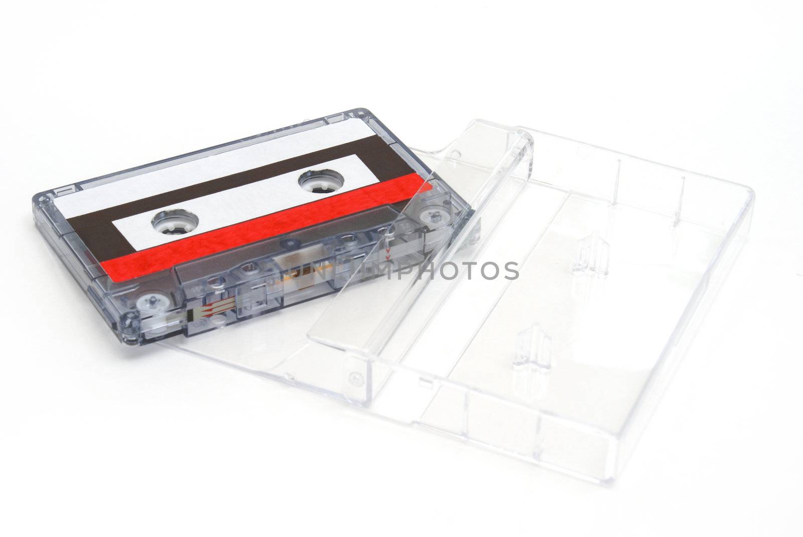 A cassette tape with its case on white background.