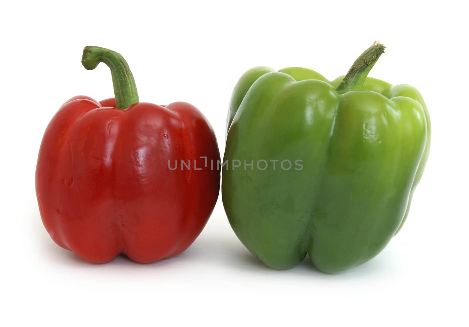 A couple of red and green peppers on white background.