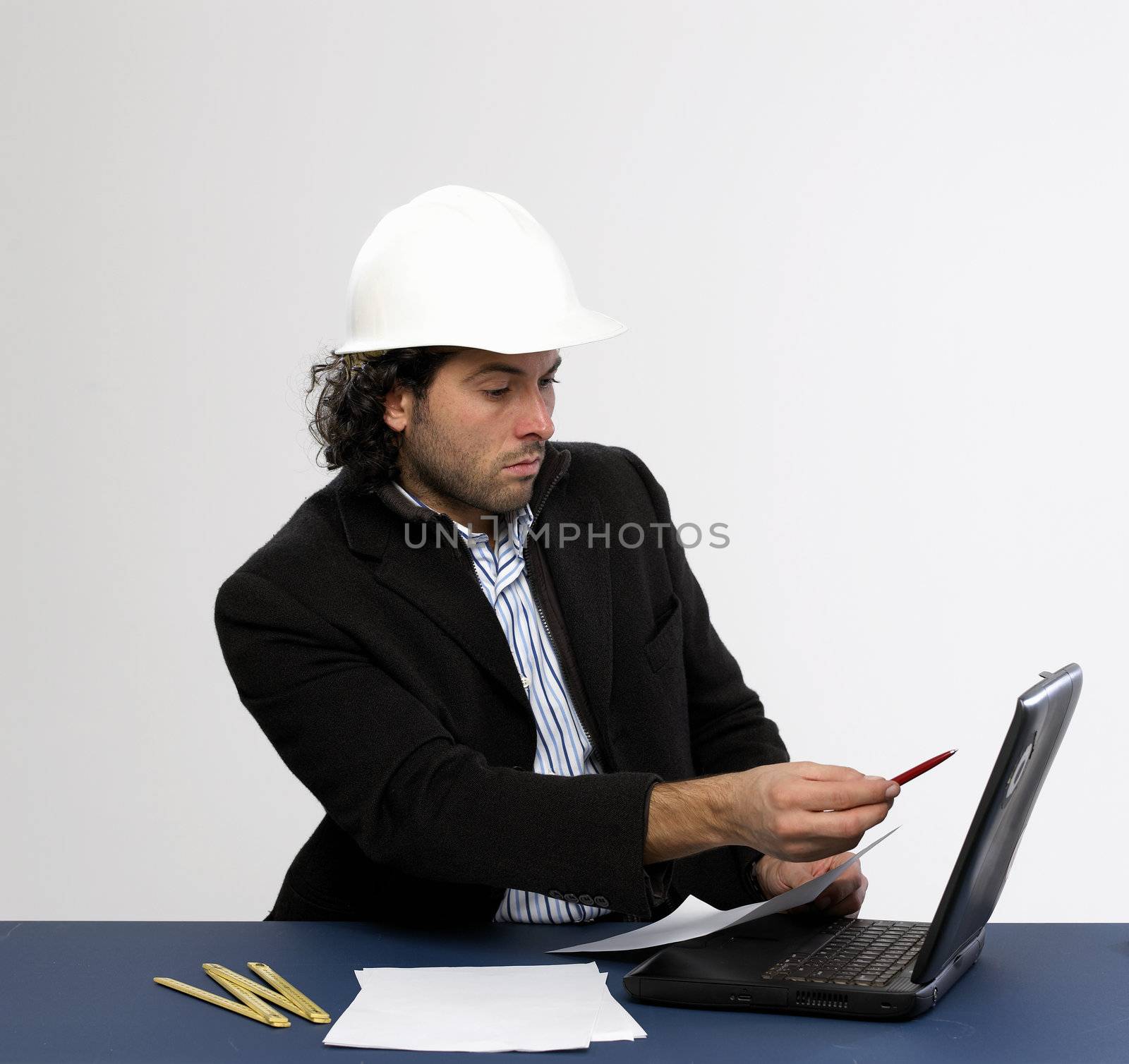 Young architect at work with laptop