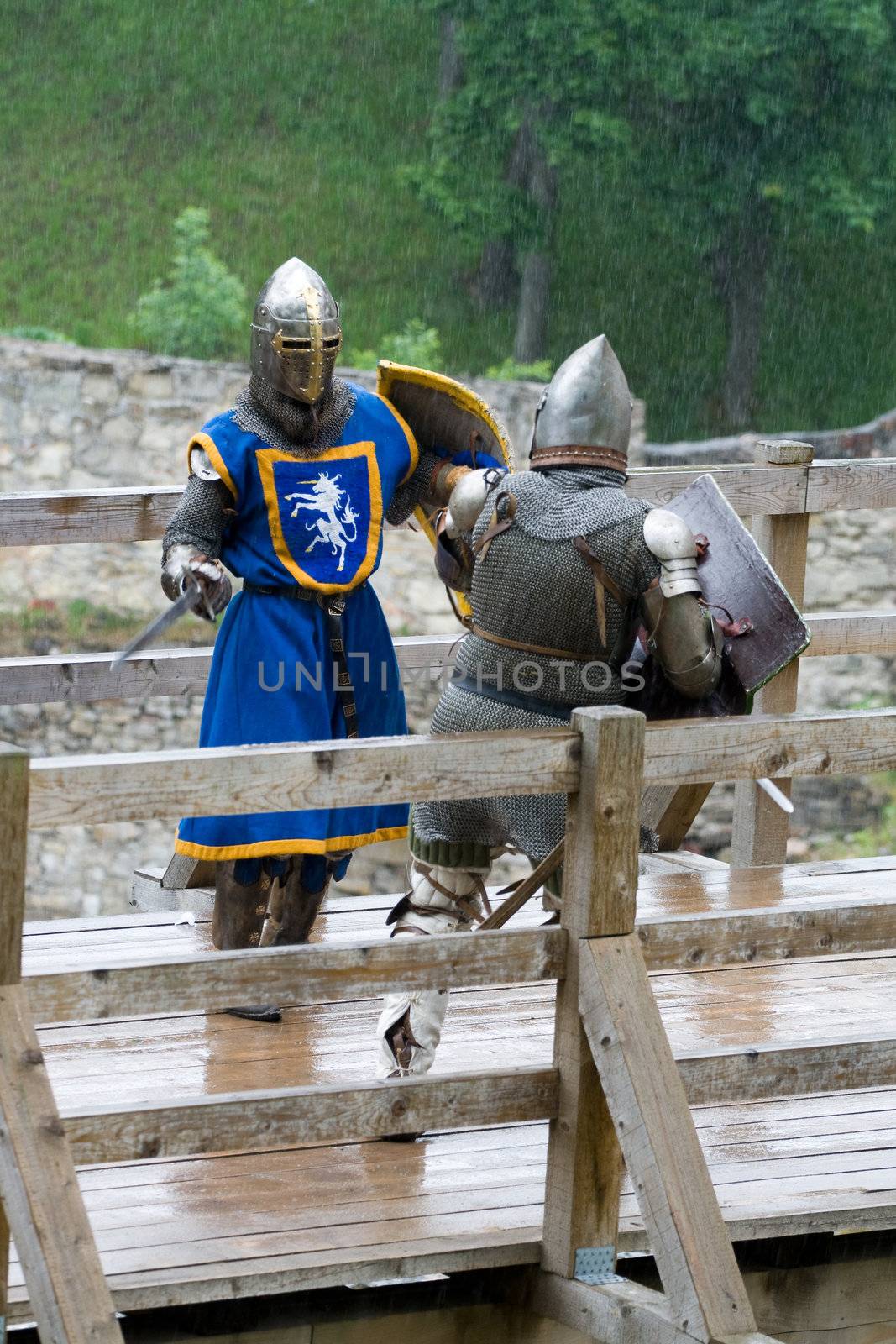 CESIS, LATVIA, June 7, 2009: Knight before swordfight on wooden bridge during the medieval festival "Livonia. 1378. Wenden". Rainy day.