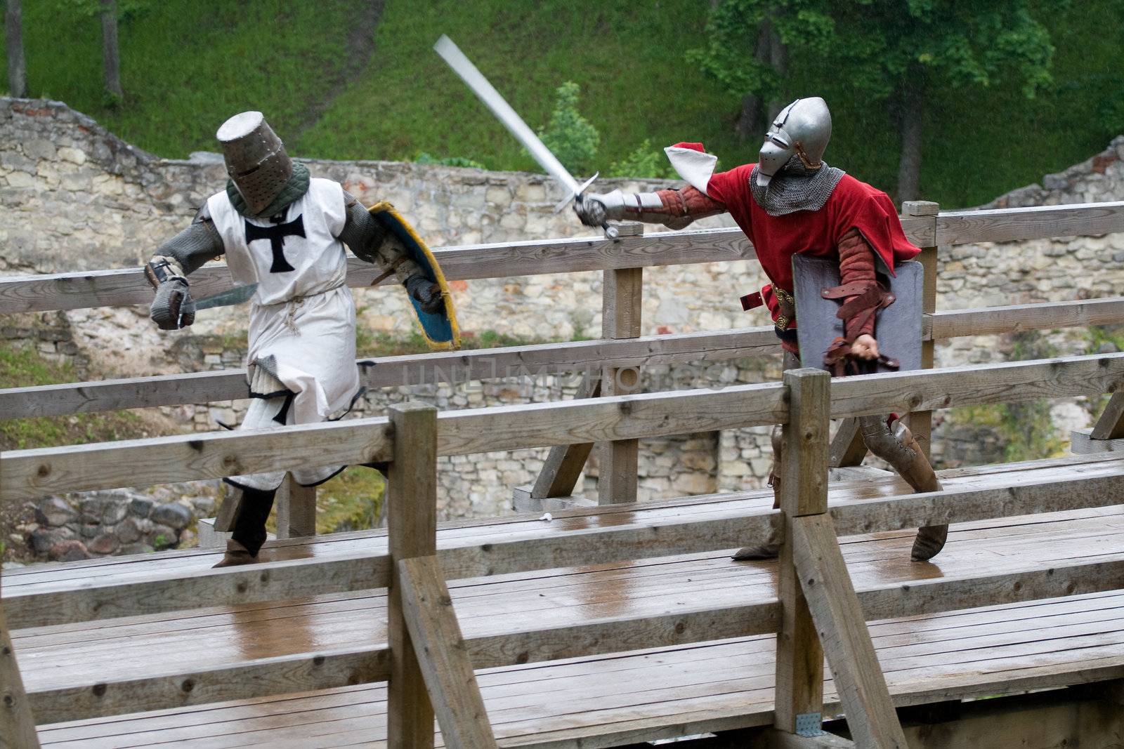 CESIS, LATVIA, June 7, 2009: Knight before swordfight on wooden bridge during the medieval festival "Livonia. 1378. Wenden". Rainy day.