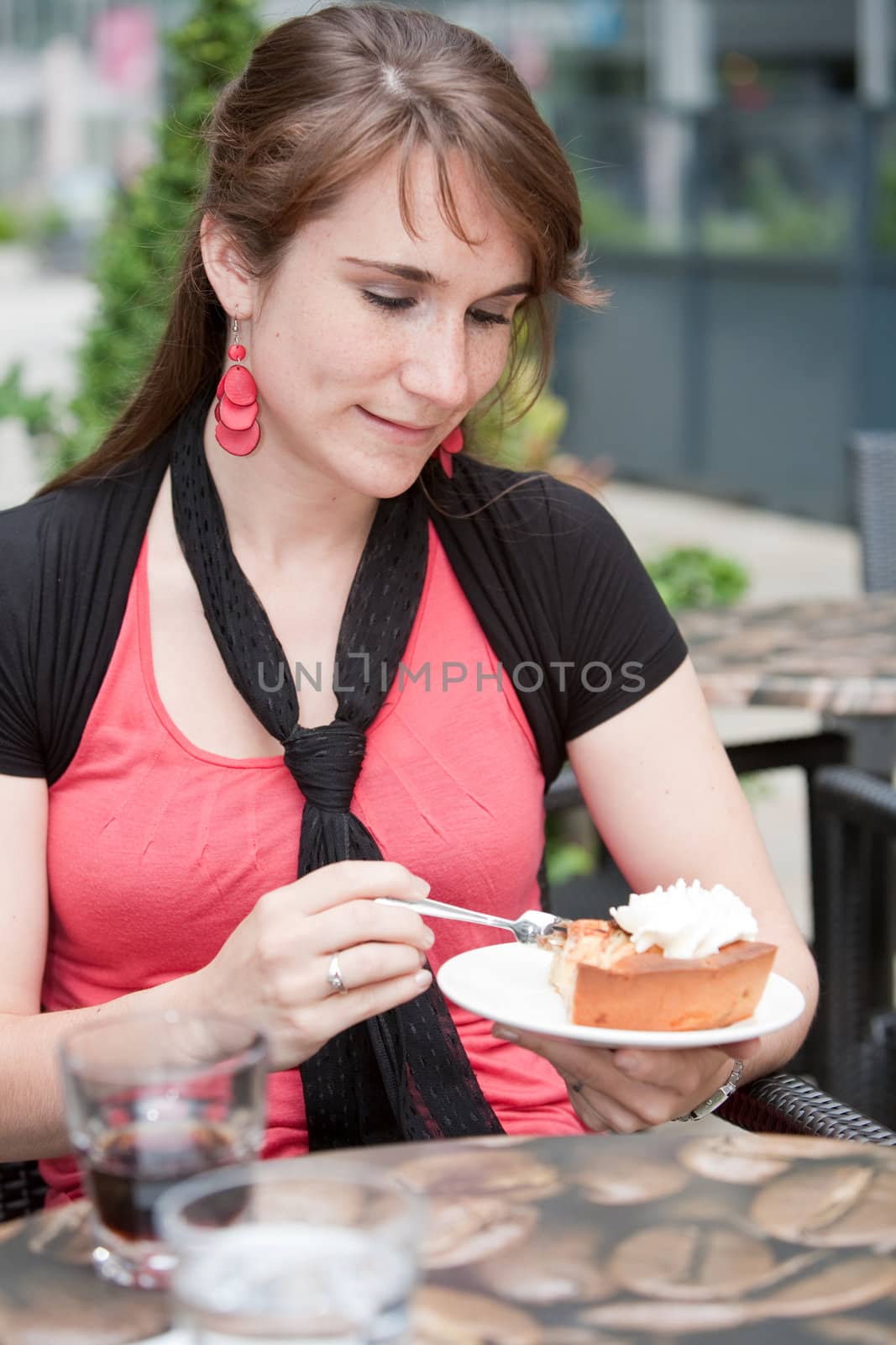 Attractive young woman having a piece of apple pie