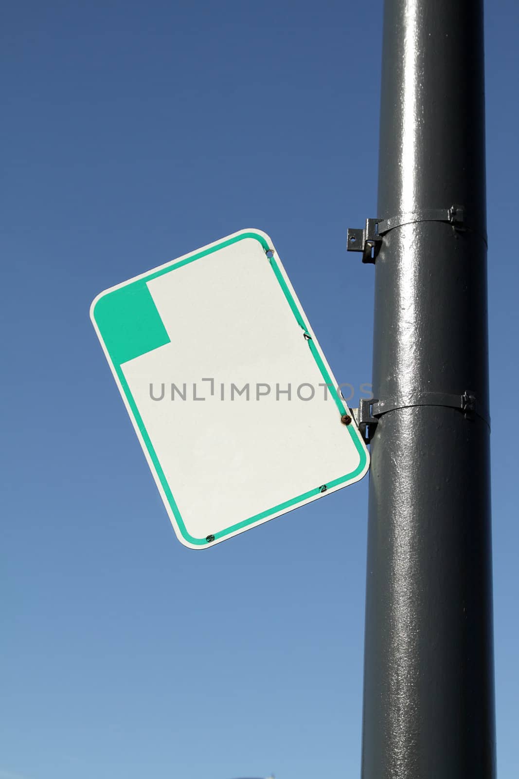 Blank parking sign on the pole on sunny day