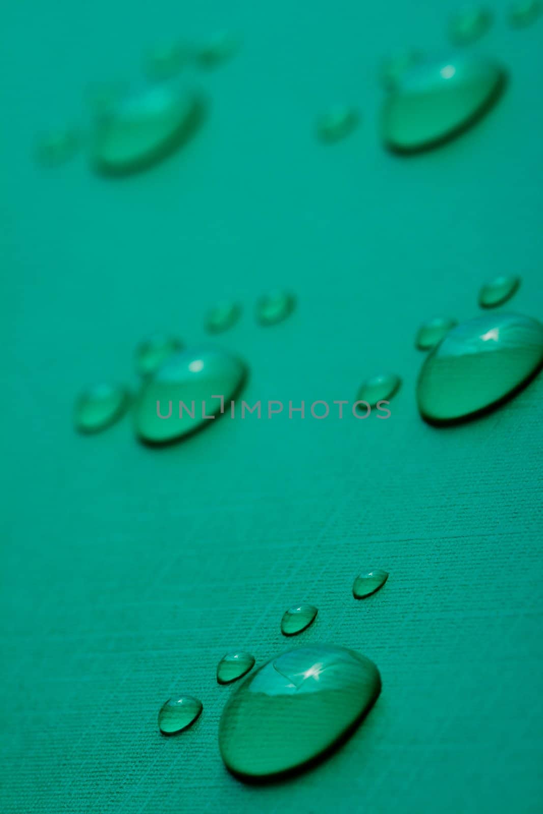 Footprints accomplished on the basis of drops of water on a green background