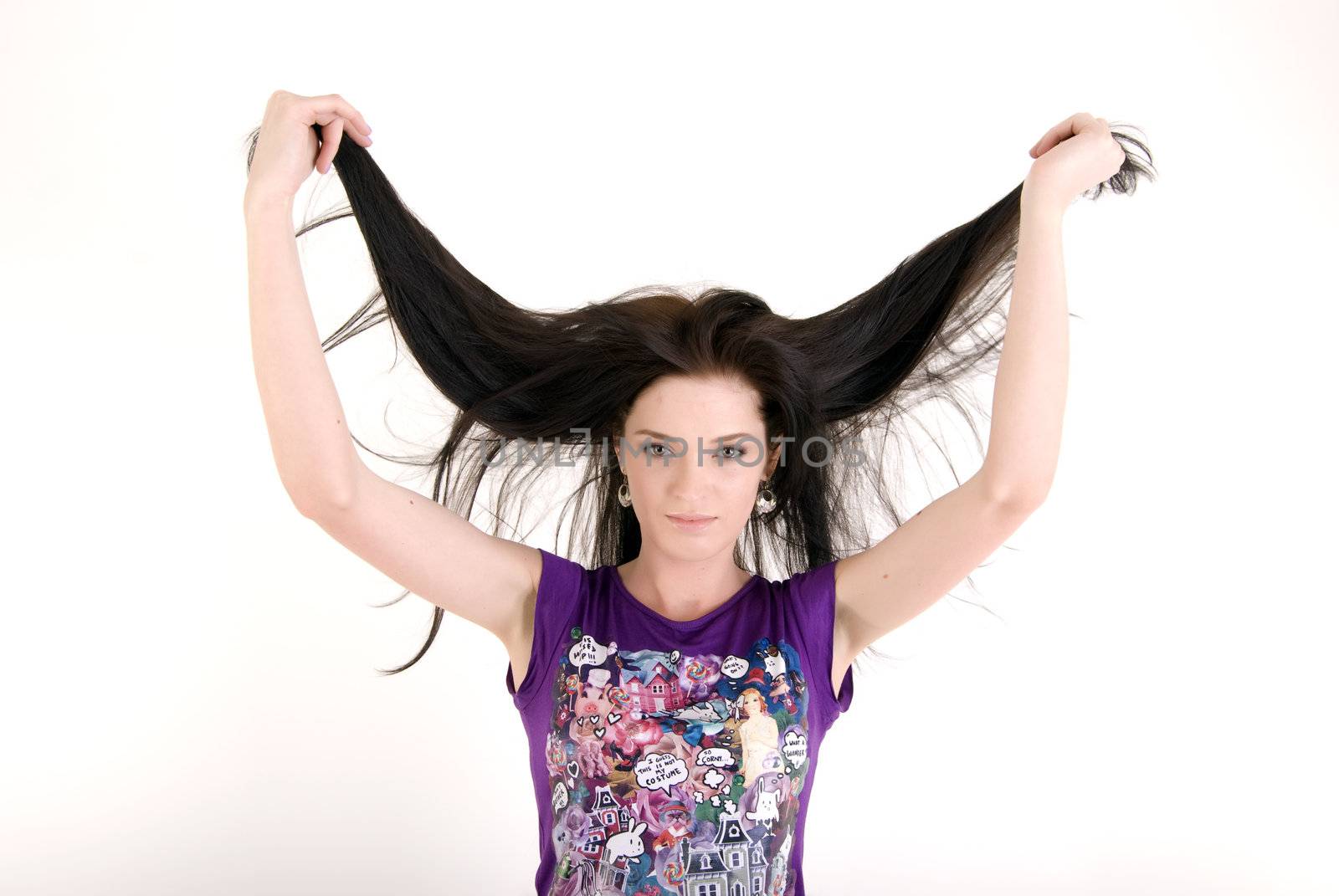 Portrait of a young beautiful brunette exposing her long hair