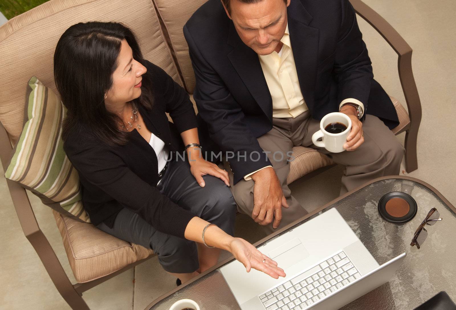 Man and Woman Using Laptop with Coffee