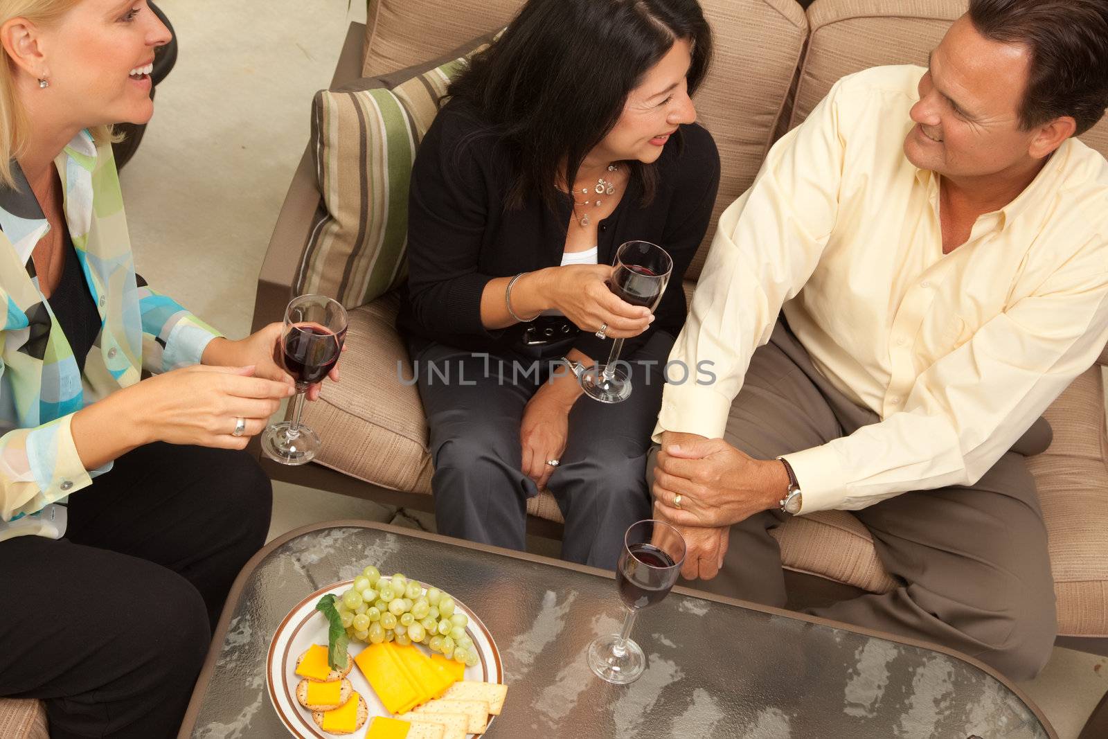 Three Friends Enjoying Wine on an Outdoor Patio.