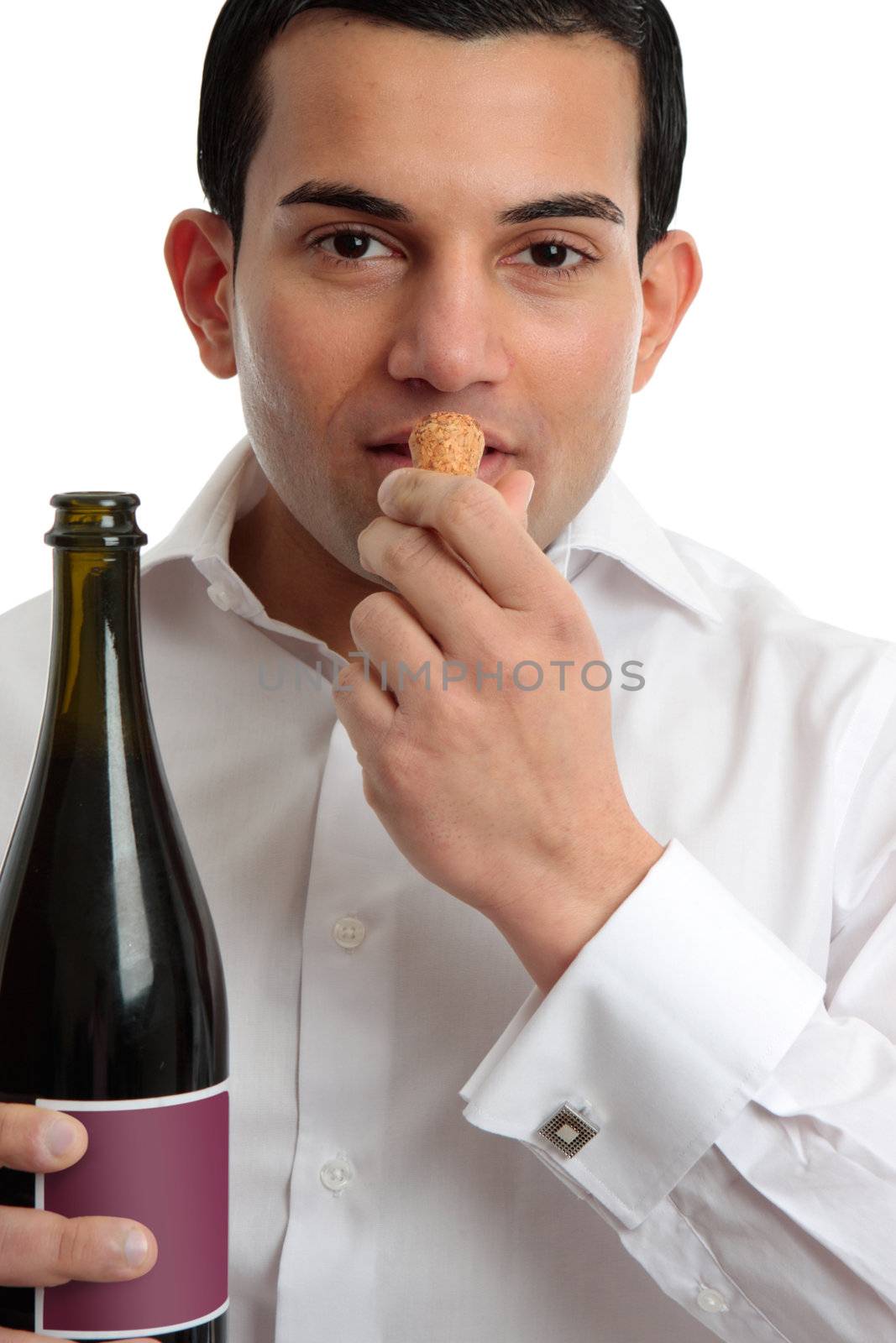 A man or wine steward sniffing the cork from wine.  White background.