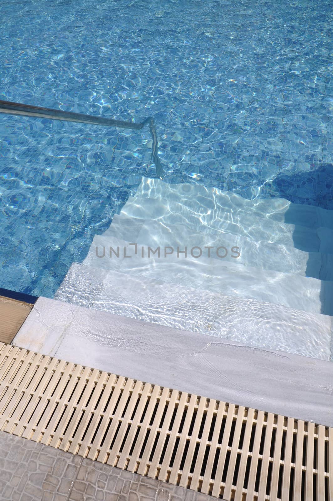 vibrant swimming pool entrance with stairs and ladder