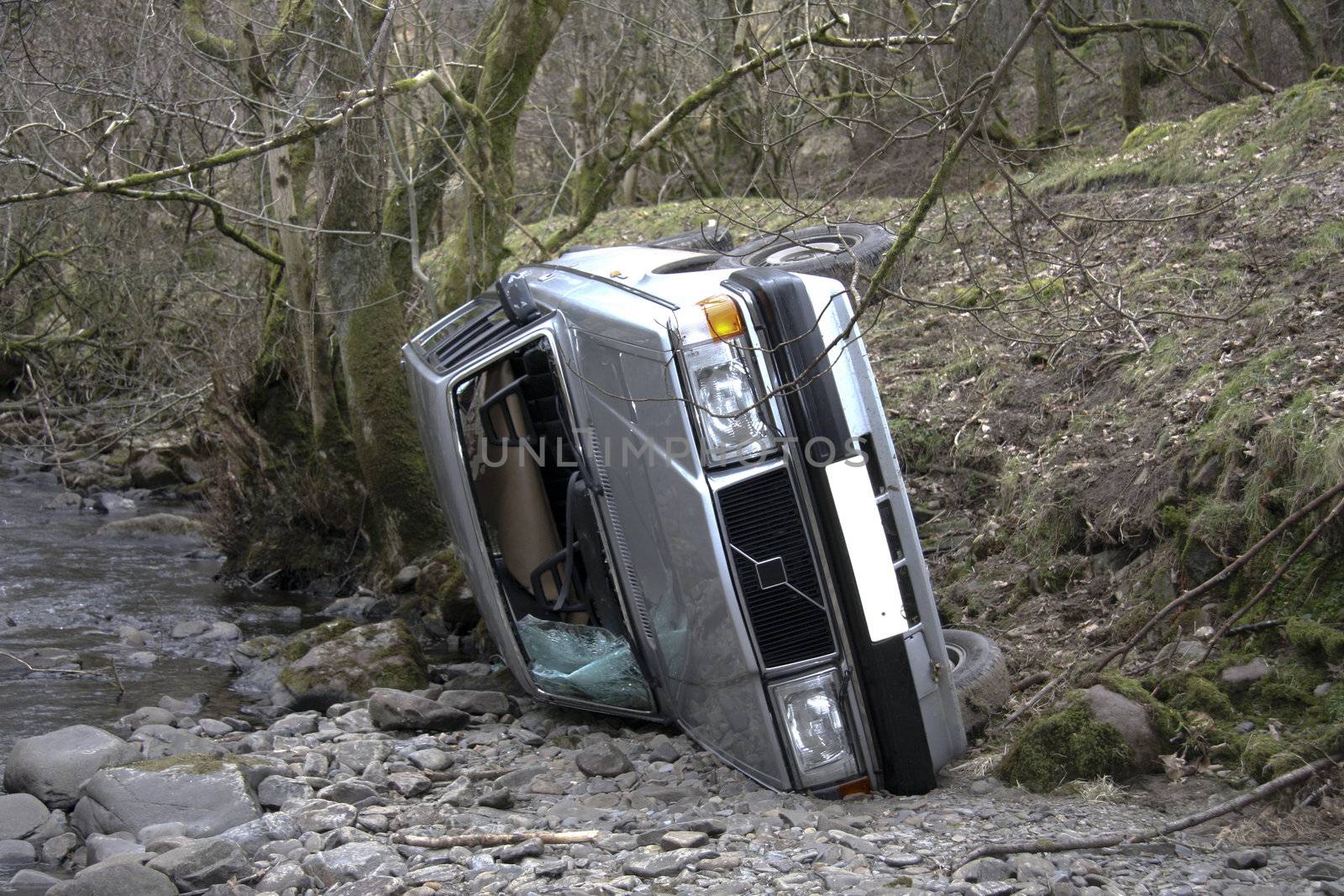 Car crash car rolled into a river bed