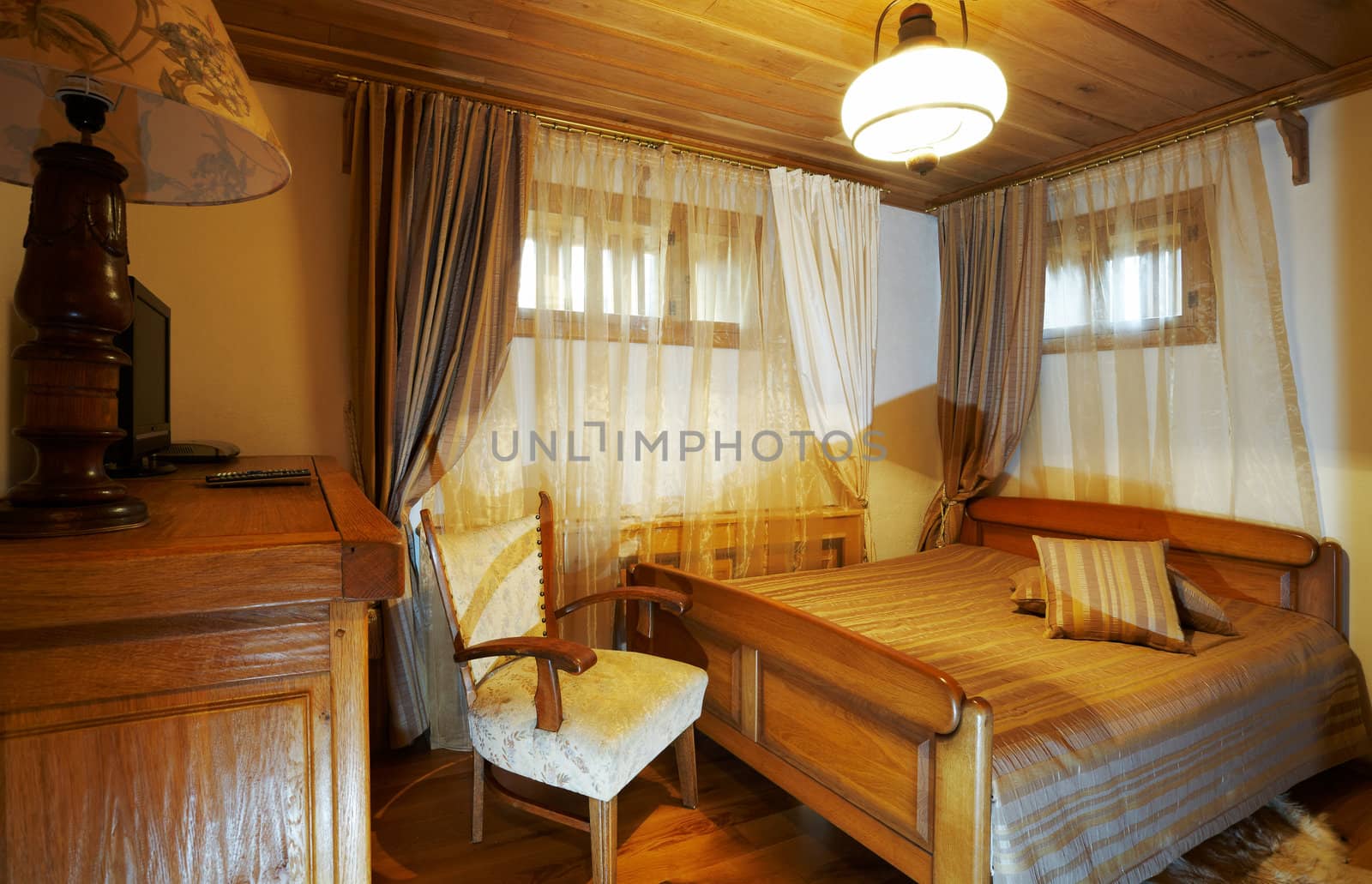 Bedroom with old style wooden furniture, hotel room interior