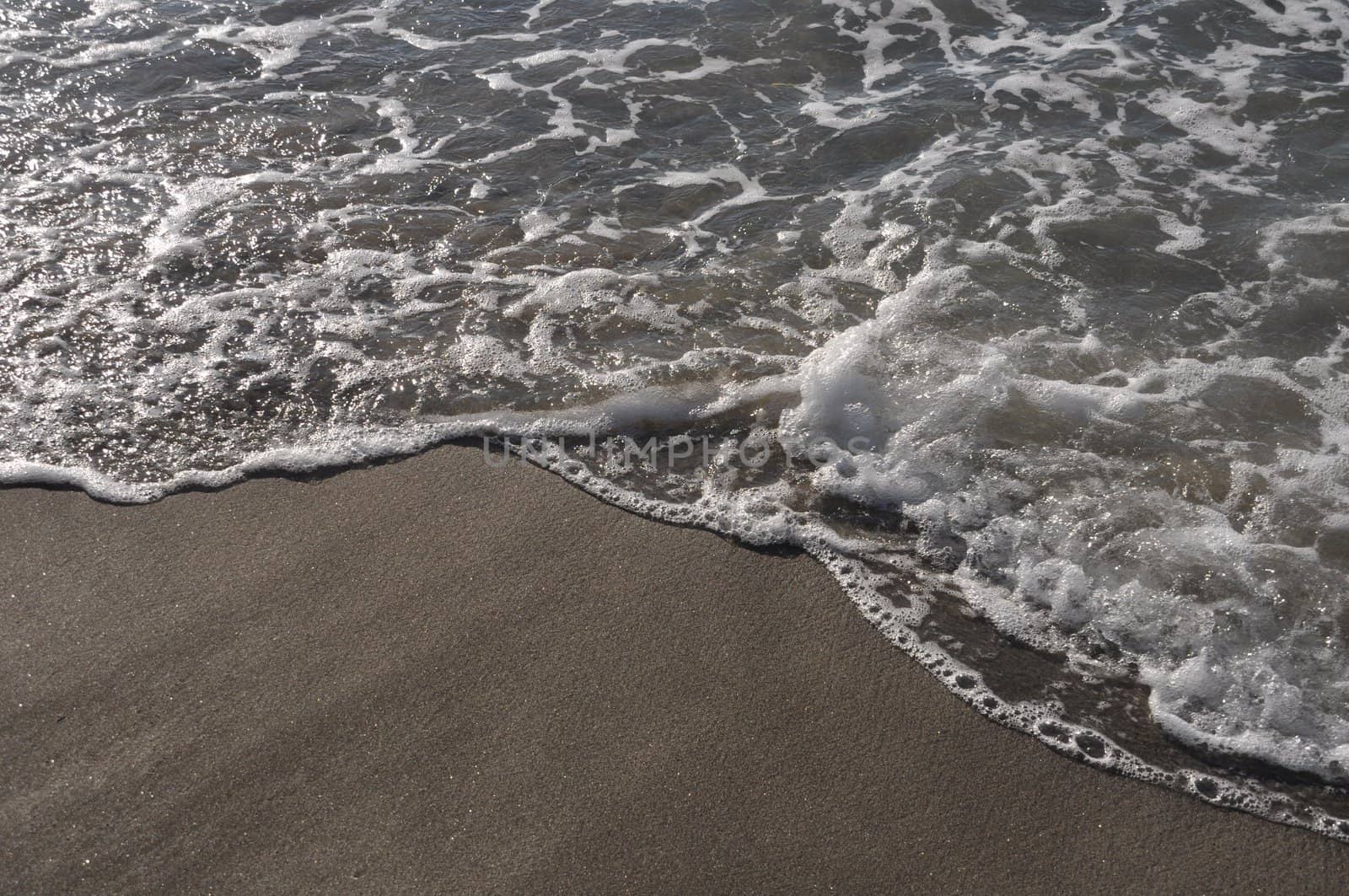 gorgeous beach sand and sea foam at sunset (copy-space available)