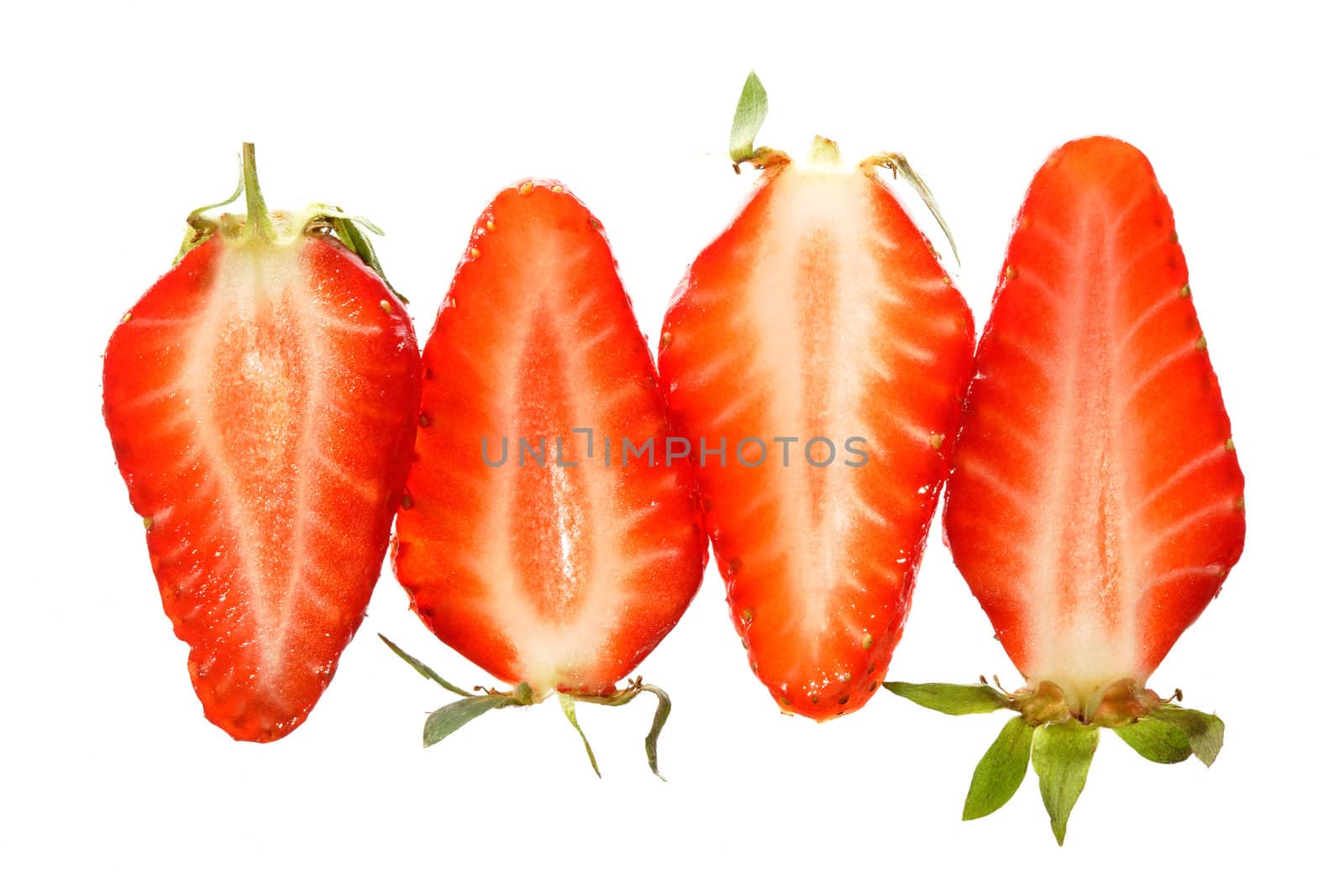 Slices of red strawberries isolated on white