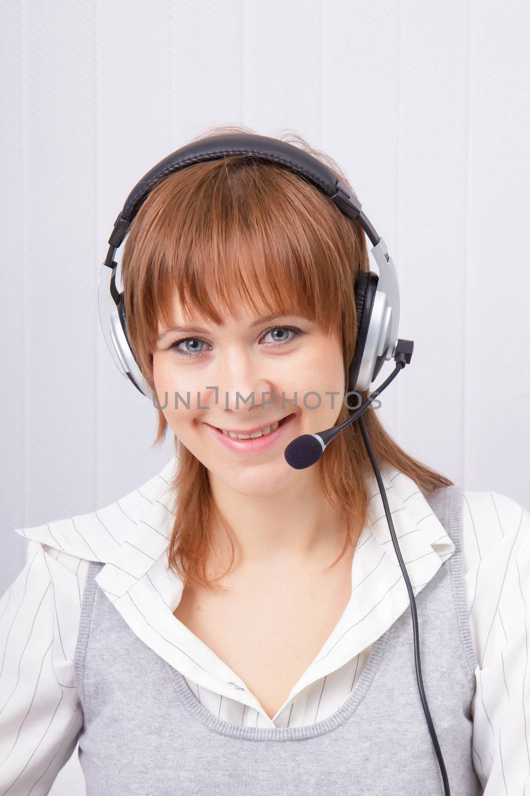 attractive girl in headphones with a microphone. Studio portrait
